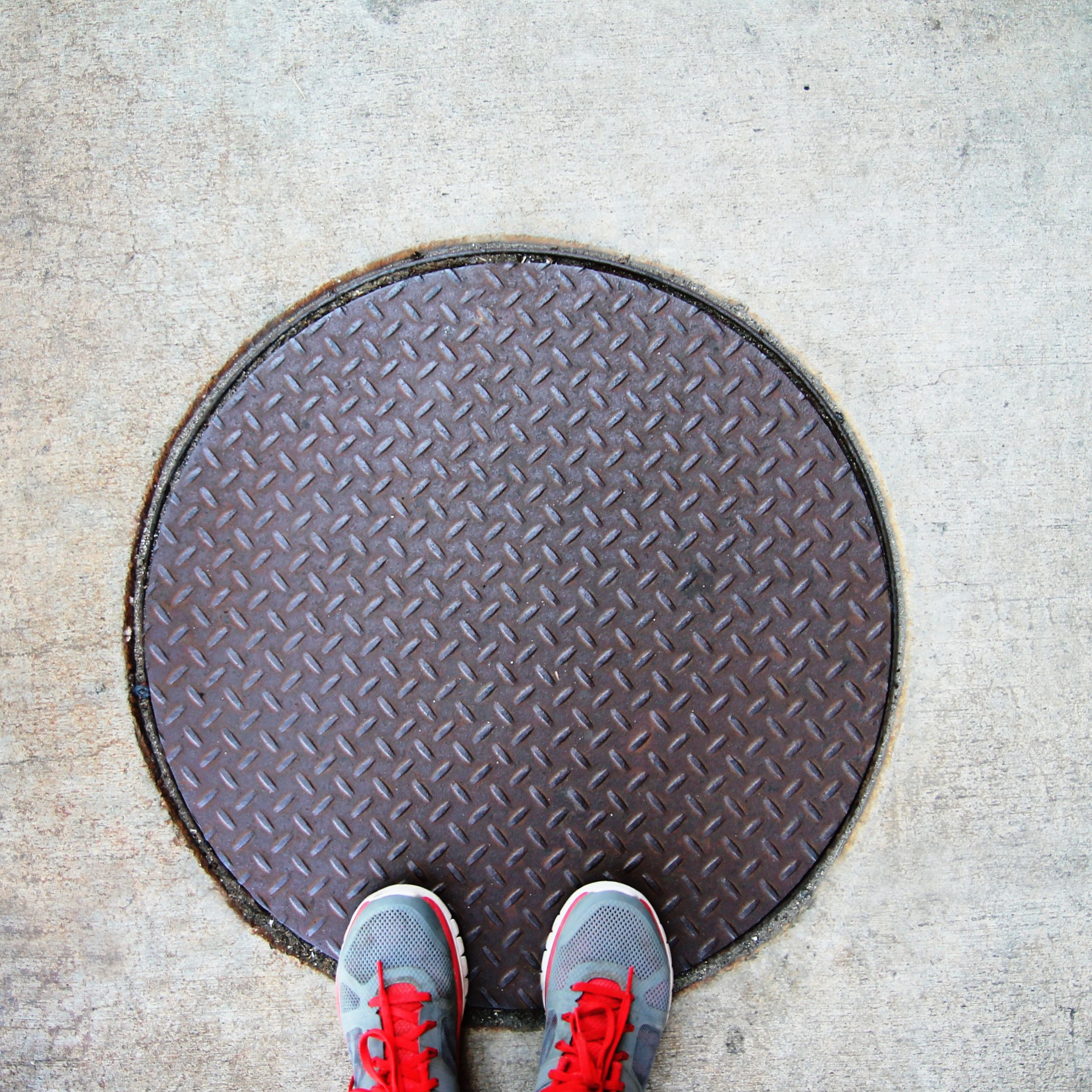 feel standing on a manhole cover