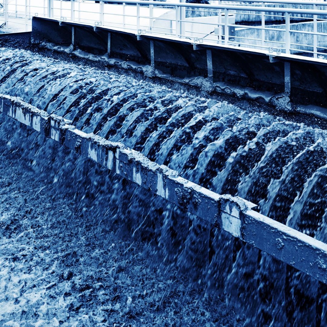 fluid flowing over barrier in industrial plant 