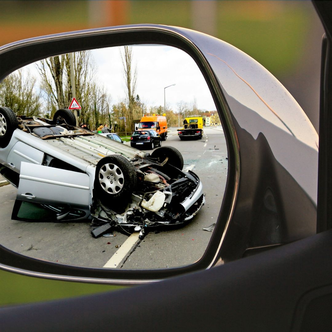 car accident with overturned car on road